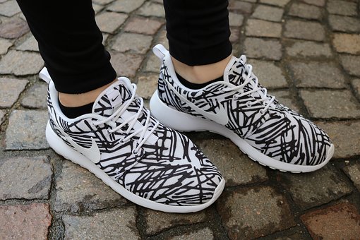 Feet in black and white shoes